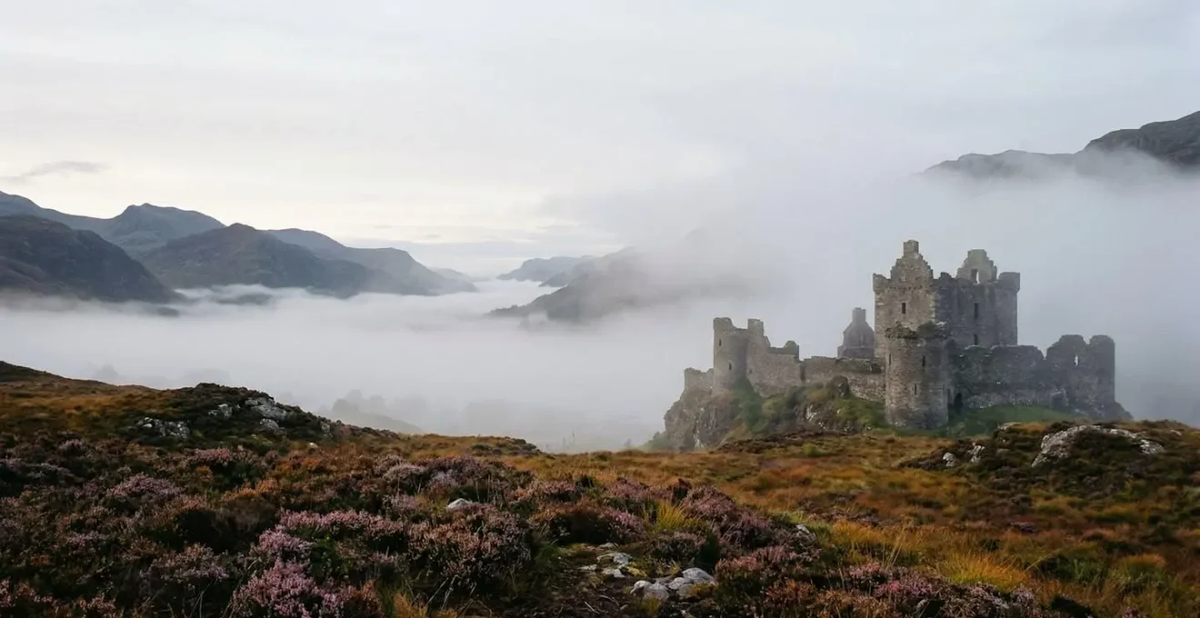Atmospheric Scottish castle ruins shrouded in morning mist during autumn off-peak season