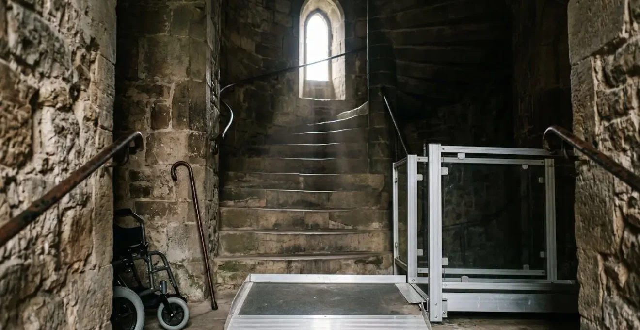 Narrow medieval stone spiral staircase showing accessibility limitations in historic castle