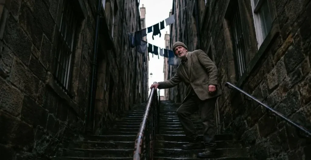 Steep narrow close between tall stone tenements in Edinburgh Old Town Steep narrow close between tall stone tenements in Edinburgh Old Town